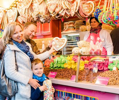 Michaelis-Kirchweih Fair Father, mother and son in front of a booth at the Michaelis Kirchweih Fair