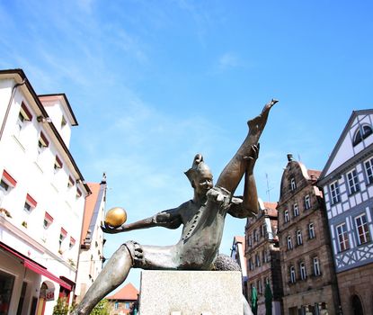 Gauklerbrunnen at the View of the Gauklerbrunnen with the sculpture of a juggler in the fore at the